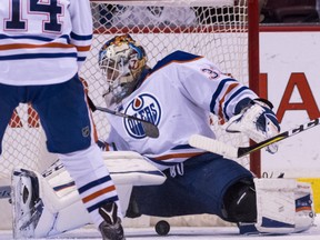 Goalie Cam Talbot of the Edmonton Oilers loses sight of the puck but keeps it out of the net after making a save against the Canucks during their game at Rogers Arena in Vancouver on Saturday night.