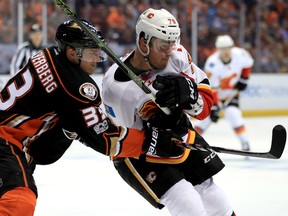 Jakob Silfverberg of the Anaheim Ducks and Micheal Ferland  of the Calgary Flames battle for position during the second period of Game 2 of their Western Conference first-round series on Saturday night at Honda Center in Anaheim, Calif.