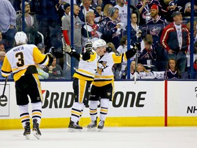 Jake Guentzel #59 of the Pittsburgh Penguins is congratulated by Sidney Crosby #87 after scoring the game-winning goal against the Columbus Blue Jackets in overtime in Game Three of the Eastern Conference First Round during the 2017 NHL Stanley Cup Playoffs on Sunday at Nationwide Arena in Columbus. Pittsburgh defeated Columbus 5-4 in overtime. Pittsburgh leads the series 3-0.