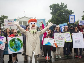 Members of the Union for Concerned Scientists pose for photographs with Muppet character Beaker in front of The White House before heading to the National Mall for the March for Science on April 22, 2017 in Washington, DC.
