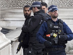 A man (L) is detained by police officers near Downing Street,  on Whitehall on April 27, 2017 in London, England.