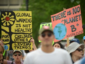 People gather near the U.S. Capitol for the People's Climate Movement before marching to the White House to protest President Donald Trump's environmental policies April 29, 2017 in Washington, DC.
