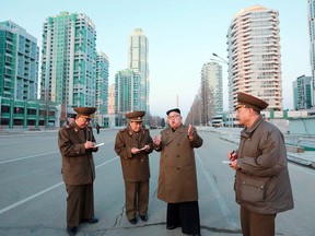 This undated picture released by North Korea's official Korean Central News Agency (KCNA) shows North Korean leader Kim Jong-Un (C) visiting construction sites in Pyongyang.