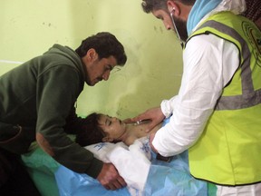 An unconscious Syrian child receives treatment at a hospital in Khan Sheikhun, Syria following a suspected chemical attack.