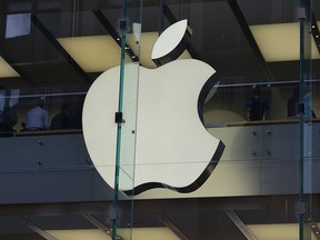 The Apple logo is displayed at a store in the central business district of Sydney on April 6, 2017. Apple was on April 6 taken to court by Australia's consumer watchdog for violating laws by allegedly refusing to look at or repair some iPads and iPhones previously serviced by a third party. / AFP PHOTO / PETER PARKSPETER PARKS/AFP/Getty Images