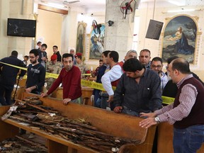 Forensics collecting evidence at the site of a bomb blast which struck worshippers gathering to celebrate Palm Sunday at the Mar Girgis Coptic Church in the Nile Delta