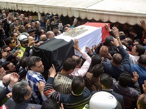 Egyptians carry the coffin of policewoman Brigadier Nagwa el-Haggar during her funeral on April 10, 2017, after she died during a blast that struck outside the Coptic Orthodox Patriarchate headquarters in the Mediterranean city of Alexandria on Palm Sunday the day before.