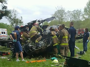 This handout photograph obtained courtesy of TheBayNet.com shows firemen investigting the wreckage of a US military UH-60 Blackhawk helicopter on April 17, 2017 at the Breton Bay Golf Course in Leonardtown, Maryland, outside Washington, DC.