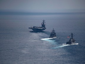 This image obtained from the US Navy shows the aircraft carrier USS Carl Vinson (L) leading the Arleigh Burke-class guided-missile destroyer USS Michael Murphy (C) and the Ticonderoga-class guided-missile cruiser USS Lake Champlain  in the Indian Ocean on April 14, 2017.