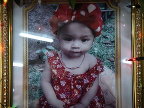 A memorial photograph of slain 11-month old girl Natalie is displayed at a temple in Phuket on April 27, 2017.  Thai media came under fire on April 26 for publishing images of a man killing his infant daughter in a Facebook Live video, a grim case that sparked outrage and raised fears of copycat killings.