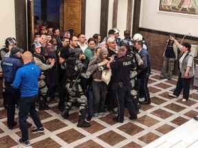 Policemen try to contain protesters trying to enter Macedonia's parliament to protest against against what they said was an unfair vote to elect a parliamentary speaker