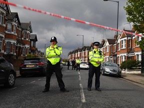 British police officers secure a cordon in a residential street in north-west London on April 28, 2017