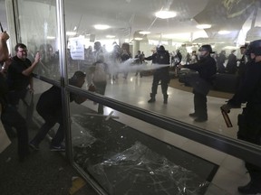 Police officers attempt to break into the Brazilian National Congress Tuesday, April 18, 2017
