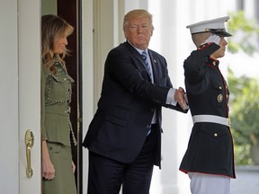 President Donald Trump pats a U.S. Marine on the back after he and first lady Melania Trump walked Argentine President Mauricio Macri and his wife Juliana Awada to their vehicle outside the West Wing of the White House in Washington, Thursday, April 27, 2017.