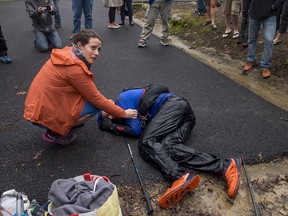 Gary Robbins collapses at the finish line of the Barkley Marathons on Monday, while his wife looks up at race director Gary Cantrell.