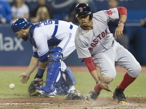 Boston Red Sox's Mookie Betts scores on a double by teammate Hanley Ramirez in the fifth inning of their game against the Blue Jays in Toronto on Tuesday night.