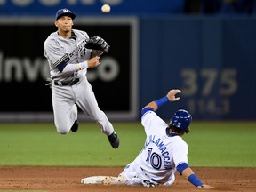 Milwaukee Brewers shortstop Orlando Arcia turns the double play after forcing out the Blue Jays' Jarrod Saltalamacchia in the ninth inning of their game at Rogers Centre in Toronto on Wednesday night.