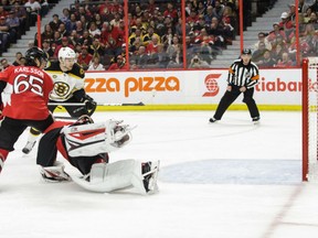 Sean Kuraly of the Boston Bruins manages to beat Ottawa Senators' goaltender Craig Anderson with the game-winning goal in Game 5 of their East Conference quarter-final Friday in Ottawa. Kuraly had a pair of goals including the winner in double overtime to keep the Bruins' season alive by virtue of their 3-2 victory, cutting the Senators' lead in the series to 3-2 with Game 6 Sunday in Boston. Trying to help Anderson is Ottawa defenceman Erik Karlsson.