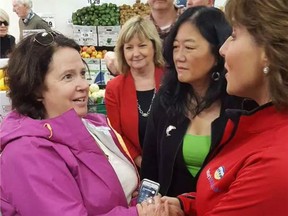 Linda Higgins, left, a retired social- worker assistant from the Sunshine Coast, said it was just 'a fluke' that she bumped into Clark while the premier was meeting and greeting voters at a North Vancouver grocery store.