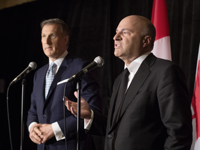 Federal Conservative leadership candidate Kevin O'Leary announces on Wednesday he is stepping out of the race and backing fellow candidate Maxime Bernier, left.
