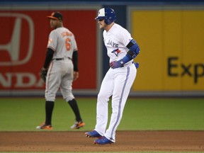 Josh Donaldson hobbles into second base after hitting an RBI double against the Baltimore Orioles on April 13. Donaldson injured his calf on the play.