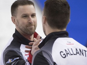 Brad Gushue, left, and Brett Gallant celebrate their 7-4 win over Team Sweden in the 1-2 Page Playoff game at the men's world curling championships ongoing in Edmonton. The Gushue rink advances to Sunday's final without a loss in its 12 games at the worlds.