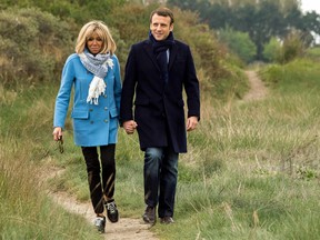 The revolution will be sharply dressed: Emmanuel Macron and his wife Brigitte pose for the photographs, on April 22, 2017, in Le Touquet, northern France.