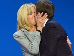 French presidential election candidate Emmanuel Macron kisses his wife Brigitte Trogneux  at the Parc des Expositions in Paris, on April 23, 2017, after the first round of the presidential election.