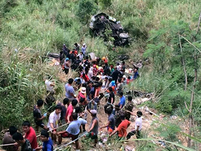 Volunteers help survivors and retrieve victims after a passenger bus fell into a ravine killing dozens in Carranglan township, Philippines on April 18, 2017.