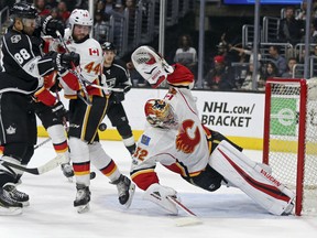 Calgary Flames' goaltender Jon Gillies stretches to the max to protect the short side while Calgary defenceman Matt Bartkowski tries to fend off Los Angeles Kings' Jarome Iginla during NHL action Thursday in Los Angeles. Gillies made 27 saves in his NHL debut as the Flames posted a 4-1 victory.