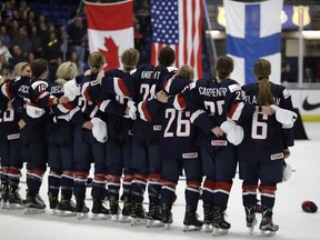 The U.S. team stands for their national anthem after defeating Canada 3-2 in overtime in the women's world hockey final on April 7.