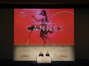 International Cannes Film Festival General Delegate, Thierry Fremaux (L) and Festival President Pierre Lescure, sitting below the 70th International Cannes Film Festival General's official poster.