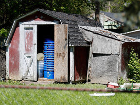 A shed stands in a backyard where police say a man with mental health problems kidnapped a neighbor and kept her trapped in a small grave-like pit, Wednesday, April 26, 2017, in Blanchester. Ohio.
