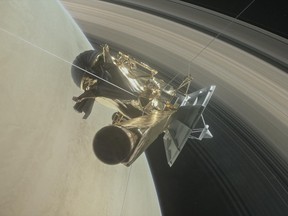 This illustration shows NASA's Cassini spacecraft about to make one of its dives between Saturn and its innermost rings as part of the mission's grand finale.