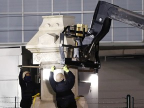Workers dismantle the Liberty Place monument Monday, April 24, 2017, which commemorates whites who tried to topple a biracial post-Civil War government, in New Orleans