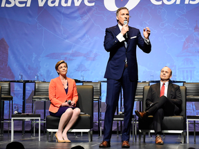 Candidate Maxime Bernier speaks as Kellie Leitch and Rick Peterson listen during the Conservative leadership debate in Toronto on Wednesday April 26, 2017.