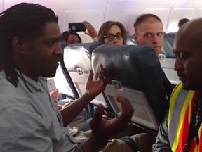 Delta passenger Kima Hamilton speaking with a Delta employee trying to remove him from the plane.