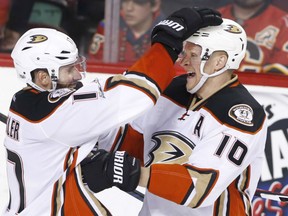 Ryan Kesler, left, congratulates overtime hero Corey Perry as the Anaheim Ducks post a 5-4 victory over the Calgary Flames in Game 3 of their West Conference quarter-final Monday night in Calgary. The victory gives the Ducks a stranglehold 3-0 lead in the best-of-seven series.