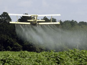 A crop duster sprays a field in Alabama. Taken Aug. 4, 2009