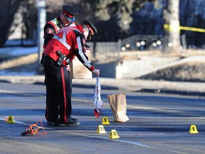 Calgary Police officers investigate the scene of a fatal hit-and-run accident involving a pedestrian in 2014.