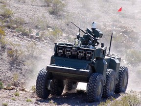 In this photo provided by the Defense Advanced Research Projects Agency/Carnegie Mellon, the U.S. Army's new Crusher combat robotic vehicle makes its way through the desert.