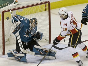 Sharks goalie Aaron Dell defends a shot against the Calgary Flames' Matthew Tkachuk during the first period of an their game in San Jose, Calif., on Saturday night.