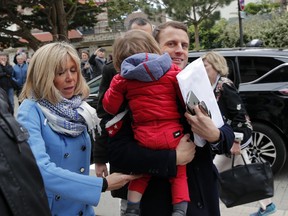 Independent centrist presidential candidate Emmanuel Macron and his wife Brigitte Trogneux arrive at their home in Le Touquet Paris Plage, northern France, Saturday, April 22, 2017.