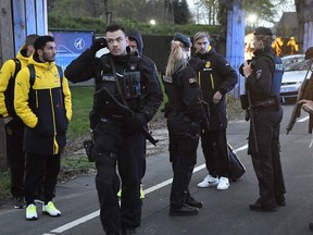 Dortmund's Marcel Schmelzer talks to police officers outside the team bus after it was damaged in an explosion before the Champions League quarterfinal soccer match between Borussia Dortmund and AS Monaco in Dortmund on April 11.