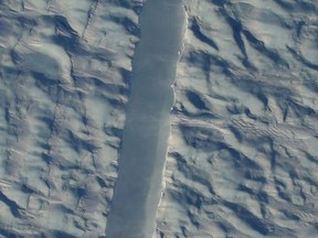 A preliminary image from NASA's Digital Mapping Service shows the new rift in Greenland's Petermann glacier, directly beneath the NASA Operation Icebridge aircraft.