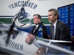 Vancouver Canucks general manager Jim Benning (left) and Trevor Linden, president of hockey operations, speak at a press conference on April 10.