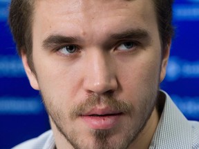 Vancouver Canucks defenceman Nikita Tryamkin listens to an interpreter during an end-of-season news conference in Vancouver on April 11.