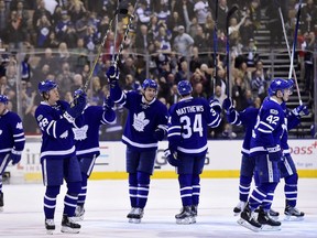 Toronto Maple Leafs players salute their fans after they clinched a playoff berth at home on April 8.