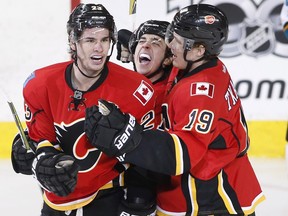 Calgary Flames forwards Sean Monahan (left), Johnny Gaudreau (centre) and Matthew Tkachuk celebrate a goal against the San Jose Sharks on March 31.