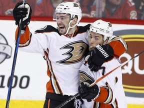 Anaheim Ducks' Logan Shaw, left, celebrates his goal with Andrew Cogliano against the Calgary Flames during third period in Calgary on Sunday.